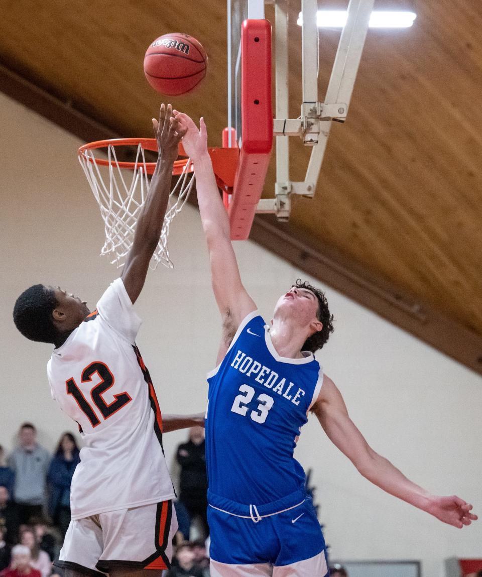 David Prouty's Judelius Neiray shoots the tying shot over Hopedale's Andrew Deppe during double overtime.