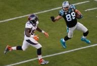 Carolina Panthers' Olsen runs with the ball past Denver Broncos' Trevathan after a reception in the second quarter of the NFL's Super Bowl 50 football game in Santa Clara