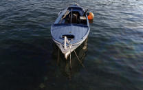In this photo taken Wednesday, March 15, 2017, a boat floats in the port of village of Bigova, 50 kilometers southwest of Podgorica, Montenegro. Montenegro, Europe's first country that declared itself "coronavirus-free," has started letting in foreign tourists as of Monday June 1, 2020, as it seeks to salvage the tourism season following the virus outbreak. (AP Photo/Darko Vojinovic)