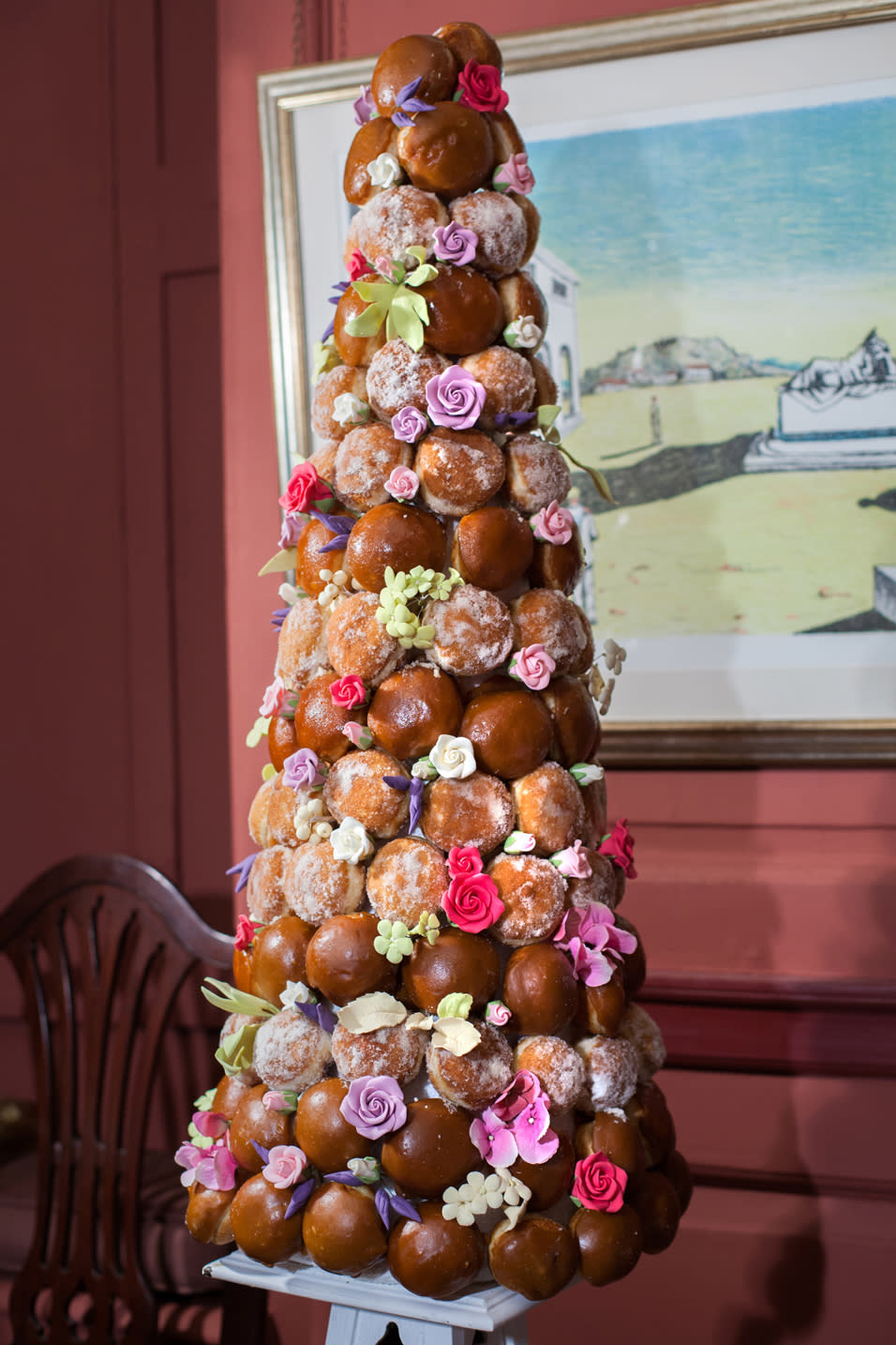A tower of cakes and doughnuts is furnished with colourful flower-shaped icing (Tate & Lyle)
