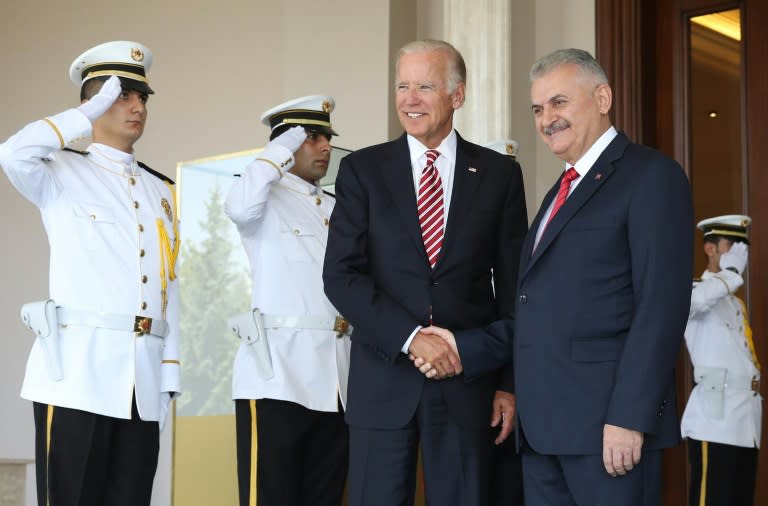 Turkish Prime Minister Binali Yildirim (R) shakes hands with US Vice President Joe Biden (L) before their meeting at Cankaya Palace in Ankara
