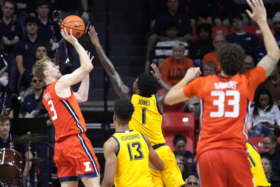 Illinois forward Marcus Domask (3) shoots over Marquette guard Kam Jones during the second half of an NCAA college basketball game Tuesday, Nov. 14, 2023, in Champaign, Ill. (AP Photo/Charles Rex Arbogast)
