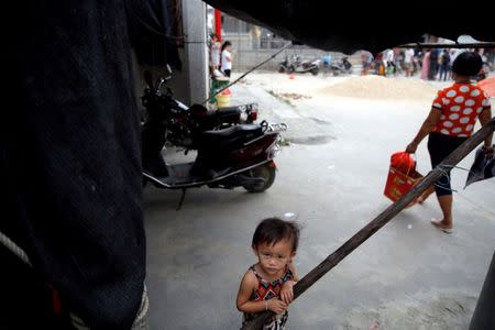 A girl plays after Tuesday's clashes between security forces and protesters in Wukan, Guangdong province, China, September 14, 2016. REUTERS/Damir Sagolj/File Photo