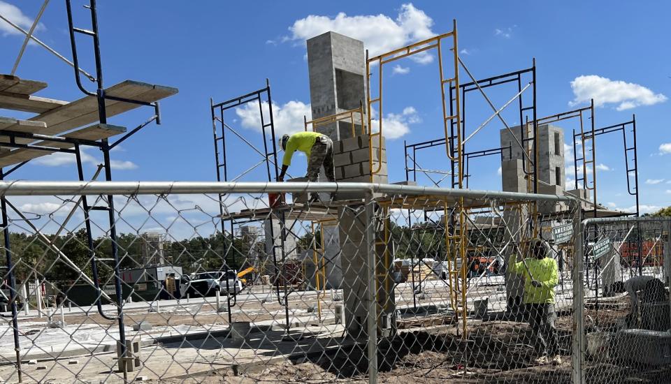 A construction crew works on the DeLand Commons project at 221 S. Woodland Blvd. in downtown DeLand.