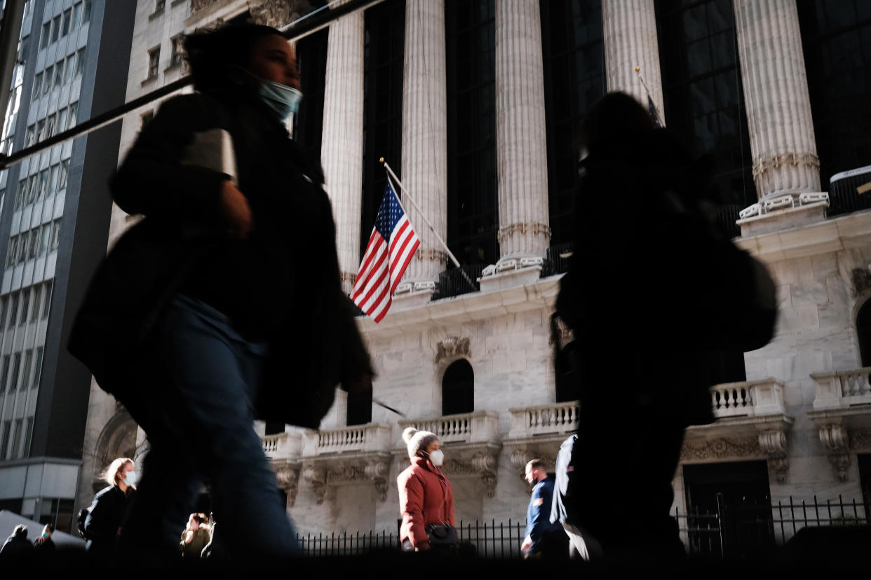 NEW YORK, NEW YORK - NOVEMBER 24: People walk past the New York Stock Exchange (NYSE) on November 24, 2020 in New York City. As investor's fear of an election crisis eases, the DowJones Industrial Average passed the 30,000 milestone for the first time on Tuesday morning.  (Photo by Spencer Platt/Getty Images)