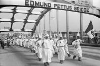 <p>A small group of Ku Klux Klansmen led by Bill Wilkerson, Imperial Wizard of the Invisible Empire from Denham Springs, La., march across the Edmund Pettus Bridge retracing Dr. Martin Luther King’s march from Selma to Montgomery, Aug. 8, 1979. (Photo: Getty Images) </p>