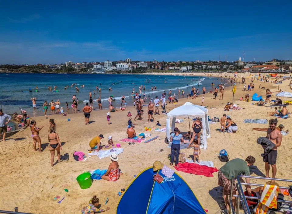 A crowded Bondi Beach on a very sunny day.