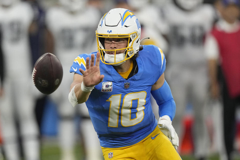 Los Angeles Chargers quarterback Justin Herbert (10) pitches to running back Austin Ekeler (30) during the first half of an NFL football game against the Dallas Cowboys, Monday, Oct. 16, 2023, in Inglewood, Calif. (AP Photo/Mark J. Terrill)