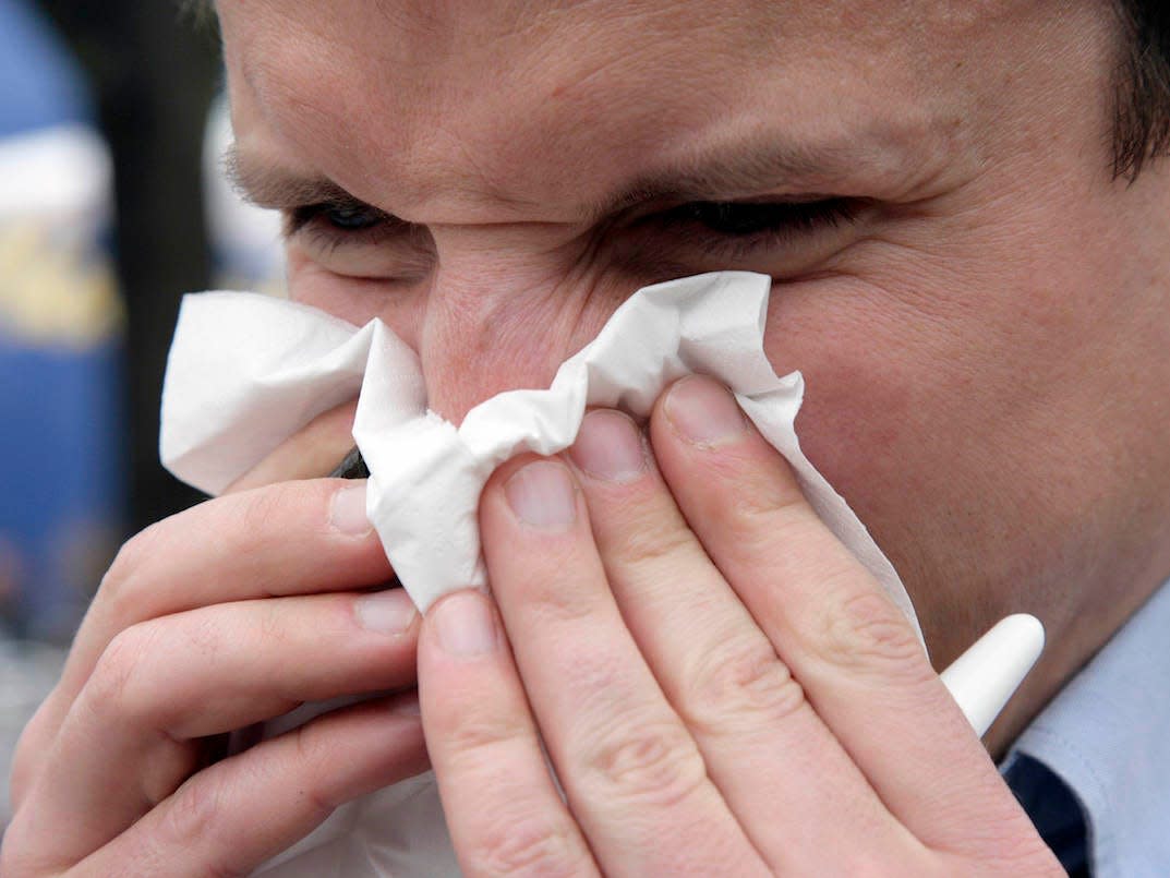 man blowing nose cold allergies