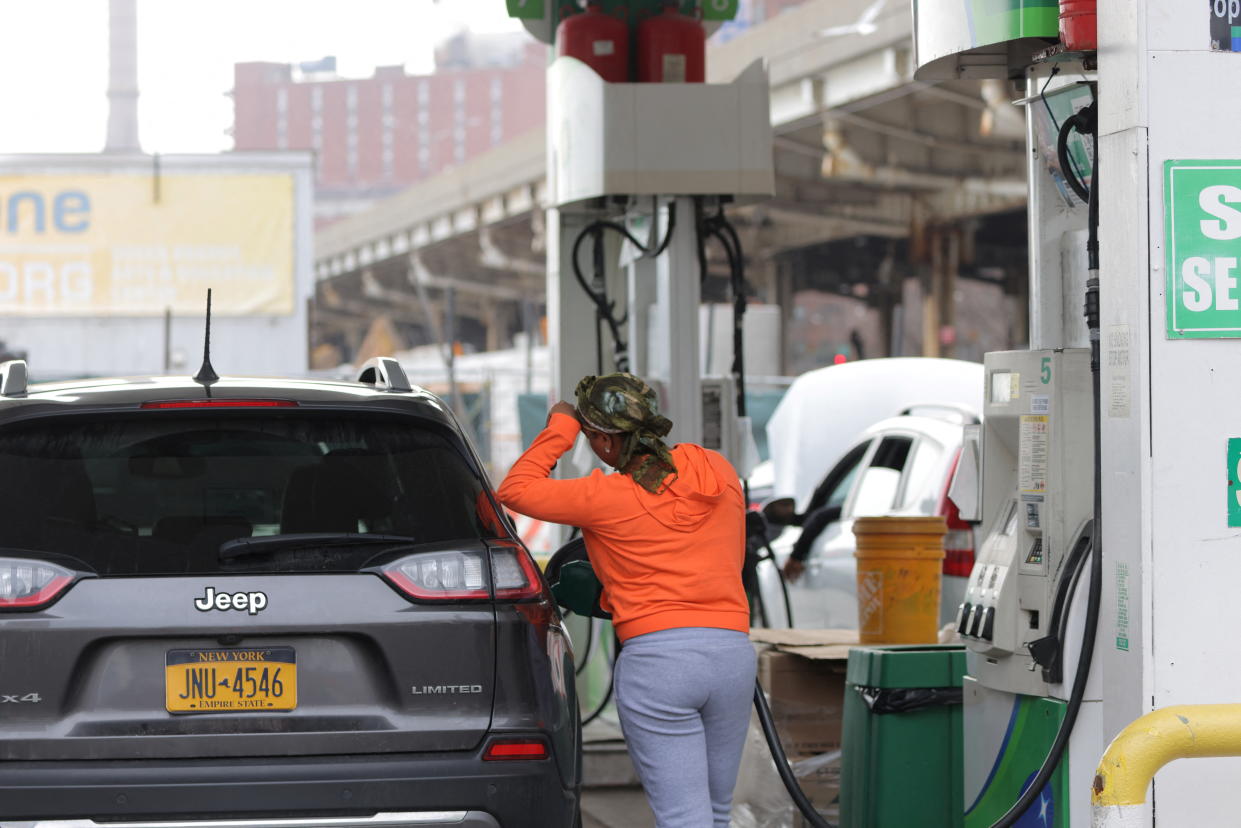 A person uses a petrol pump at a gas station as fuel prices surged in Manhattan, New York City, U.S., March 7, 2022. REUTERS/Andrew Kelly