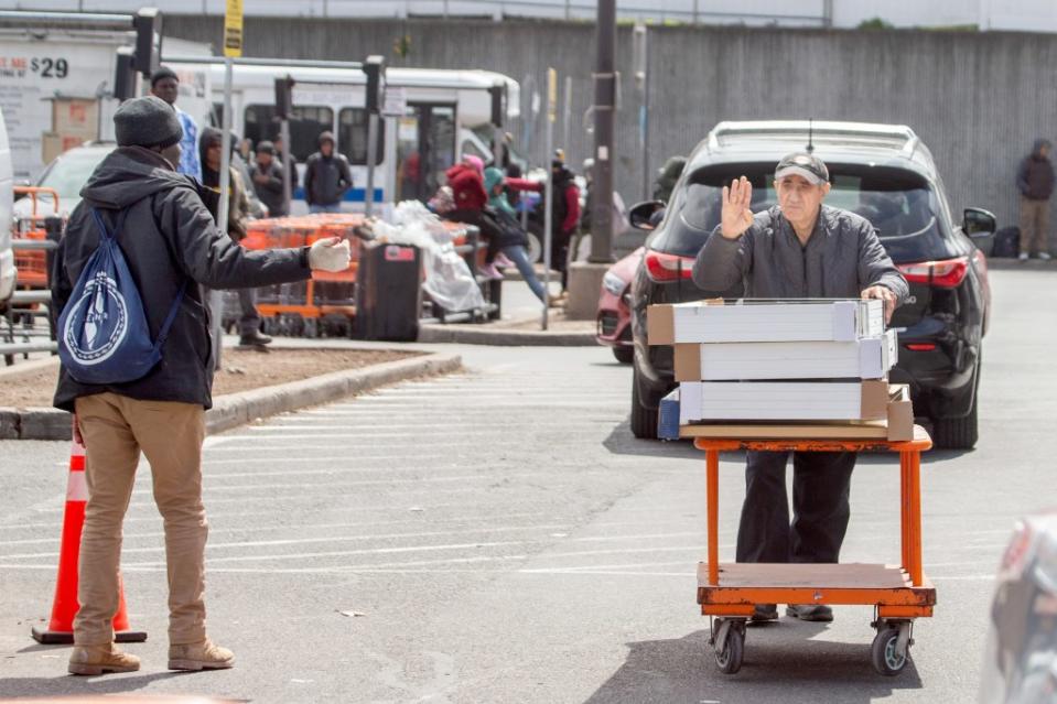 Persistent migrants flood the parking lot of the Home Depot in Throggs Neck, the Bronx. Aristide Economopoulos