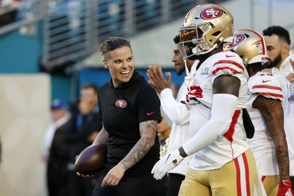 San Francisco 49ers offensive assistant Katie Sowers talks with players before the NFL Super Bowl 54 football game between the San Francisco 49ers and Kansas City Chiefs Sunday, Feb. 2, 2020, in Miami Gardens, Fla. (AP Photo/Mark Humphrey)