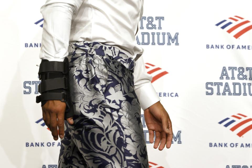 Dallas Cowboys quarterback Dak Prescott, wearing a brace on his right hand, walks away from the podium after a post game news conference following the team's 19-3 loss to the Tampa Bay Buccaneers in a NFL football game in Arlington, Texas, Sunday, Sept. 11, 2022. (AP Photo/Ron Jenkins)