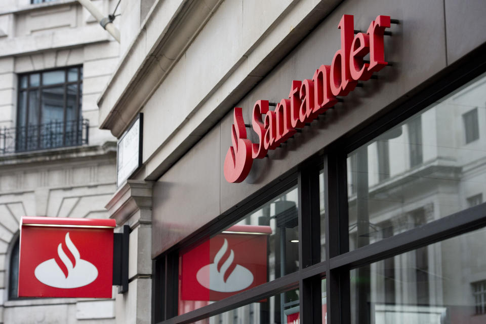 Embargoed to 0001 Monday July 15 File photo dated 14/02/15 of Santander signage above a branch. The high street lender is rolling out its global "work cafe" chain to the UK with a site in Leeds offering small businesses and entrepreneurs free co-working spaces and banking facilities.