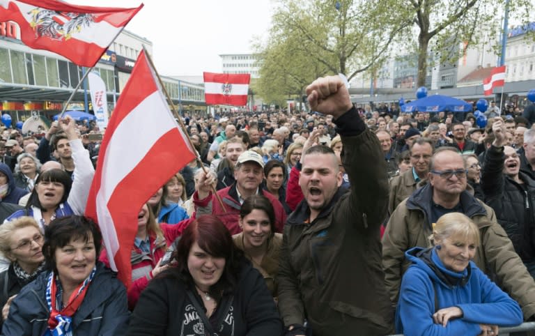 Austrian Freedom Party (FPOe) supporters react during a speech of FPOe's leader Heinz-Christian Strache during a demonstration against a refugee home in Vienna, on April 18, 2016