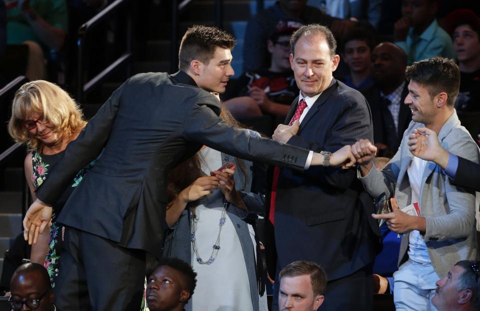 <p>Juan Hernangomez, left, is congratulated by friends and family after being selected 15th overall by the Denver Nuggets during the NBA basketball draft, Thursday, June 23, 2016, in New York. (AP Photo/Frank Franklin II) </p>