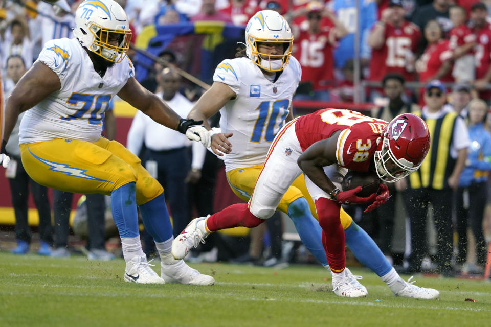 Kansas City Chiefs cornerback L'Jarius Sneed (38) intercepts a pass as Los Angeles Chargers quarterback Justin Herbert (10) and offensive tackle Rashawn Slater (70) watch during the second half of an NFL football game Sunday, Oct. 22, 2023, in Kansas City, Mo. (AP Photo/Ed Zurga)