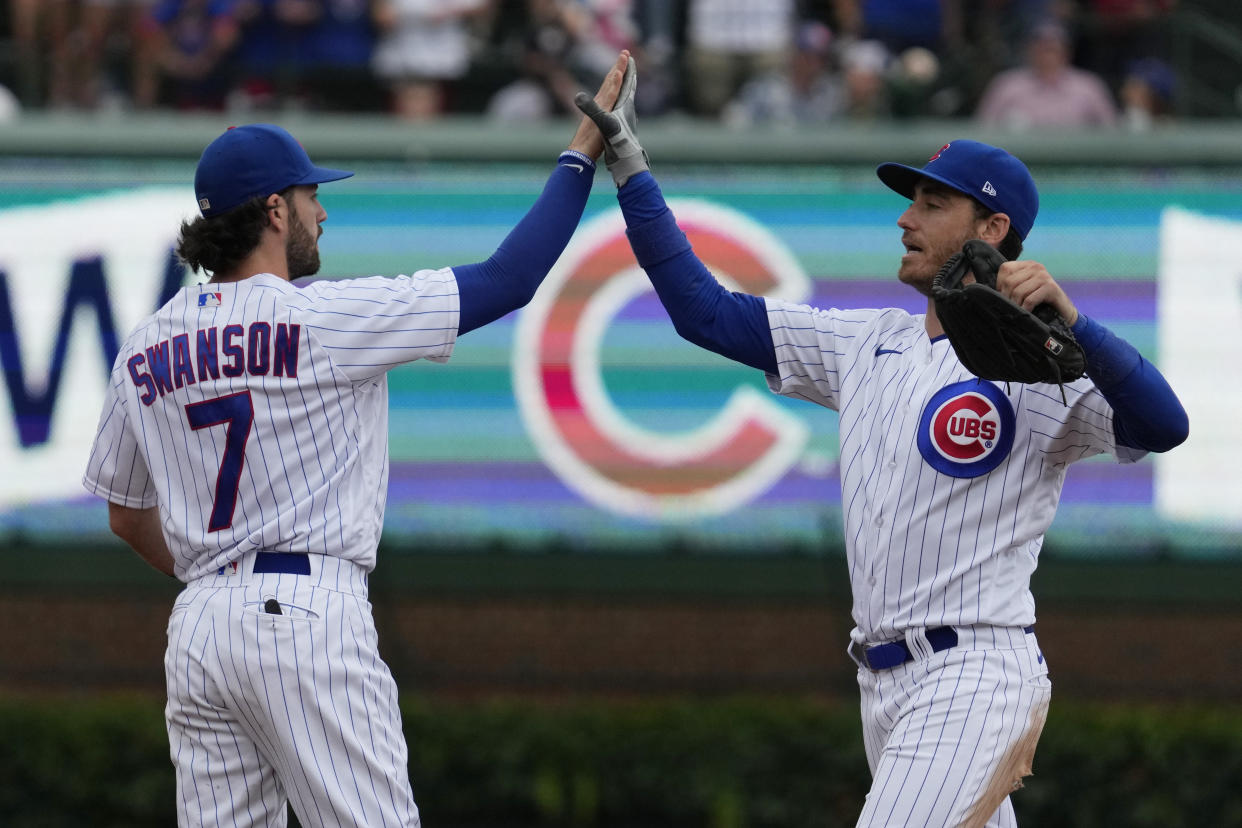 Chicago Cubs shortstop Dansby Swanson, left, and outfielder Cody Bellinger celebrate after a win over the Atlanta Braves on Sunday. (AP Photo/Nam Y. Huh)