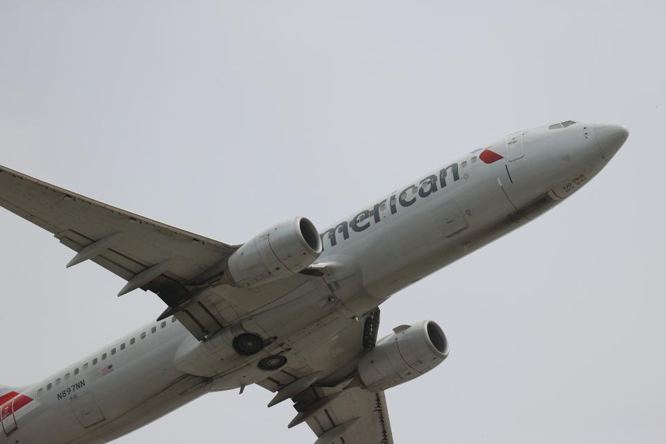 American Airlines has canceled hundreds of its weekend flights, pointing to weather disruptions in Texas. in this June 2021 photo, an American Airlines plane takes off at Miami International Airport.