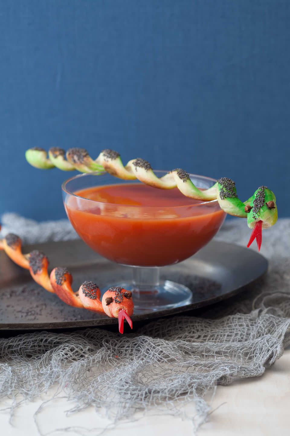 <p>Surprise partygoers with a first course featuring a wriggling reptile breadstick garnish. Gliding across a glass bowl of tomato soup, he's as delicious as he is stealthy.<br></p><p><strong><a rel="nofollow noopener" href="https://www.womansday.com/food-recipes/food-drinks/recipes/a11430/snakes-soup-recipe-122714/" target="_blank" data-ylk="slk:Get the recipe.;elm:context_link;itc:0;sec:content-canvas" class="link ">Get the recipe.</a></strong></p>