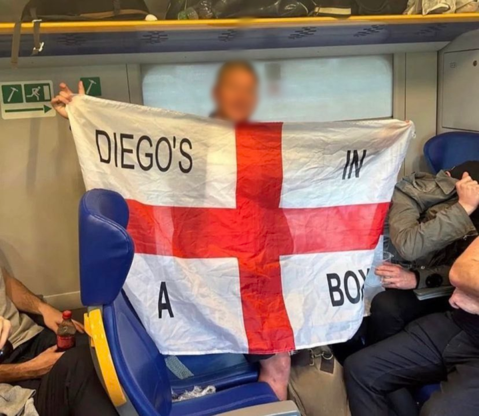 An England fan shows off the offensive flag (Twitter/The Independent)