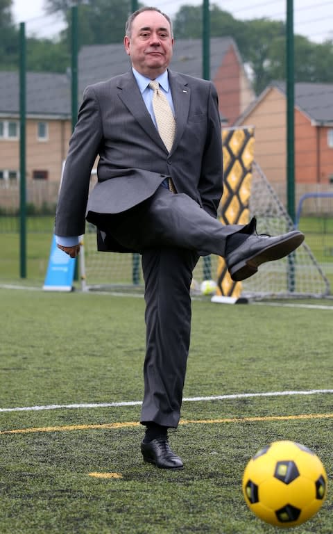 Alex Salmond kicks a football - Credit: PA