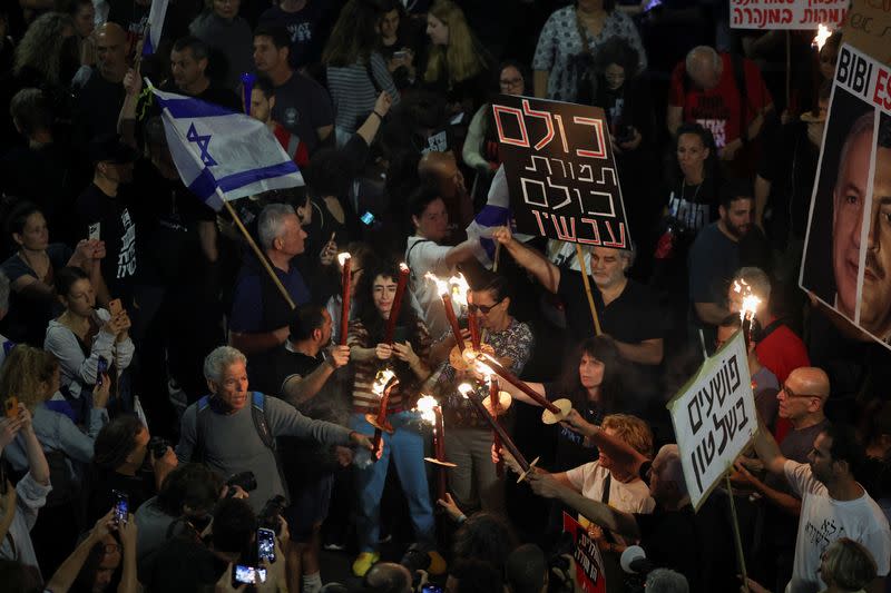 People attend a protest calling for the immediate release of hostages, in Tel Aviv