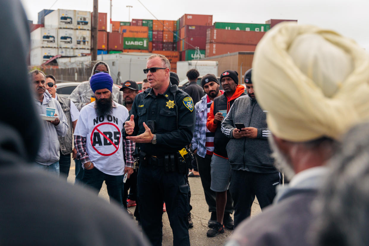 Clay Burch (Captain of Police at Oakland PD) speaks to truckers protesting AB5 at Port of Oakland in California on July 22, 2022. (Photo by Anibal Martel/Anadolu Agency via Getty Images)