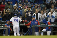 Chicago Cubs' Jonathan Villar (24) celebrates with manager David Ross right, at the dugout after hitting a solo home run during the third inning of a baseball game against the Pittsburgh Pirates Tuesday, May 17, 2022, in Chicago. (AP Photo/Paul Beaty)