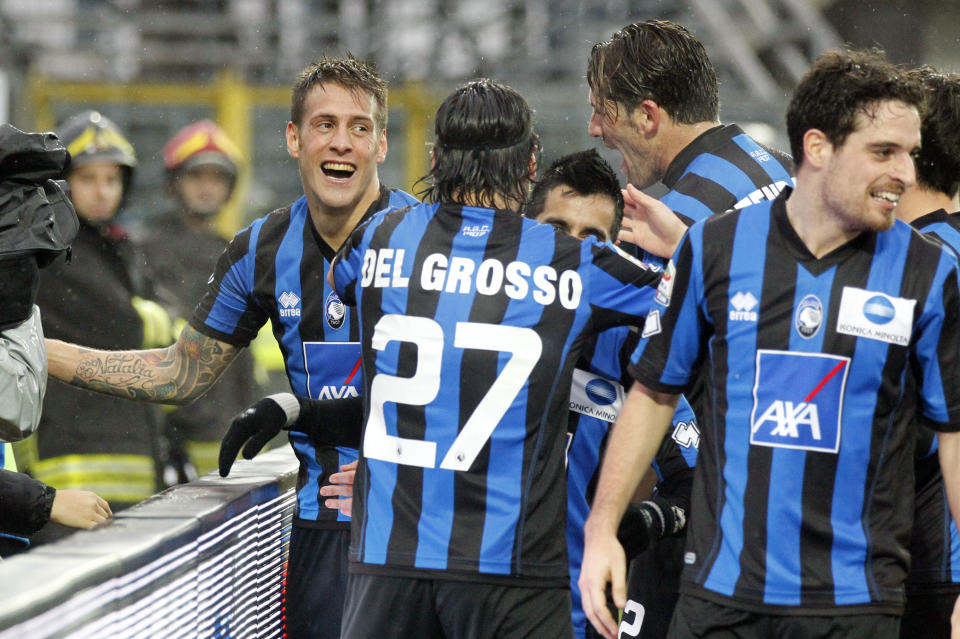 Atalanta's German Denis, left, of Argentina, is celebrated by his teammates after he scored during a Serie A soccer match against Napoli in Bergamo, Italy, Sunday, Feb. 2, 2014. (AP Photo/Felice Calabro')