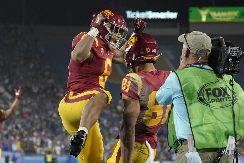 Southern California wide receiver Kyle Ford, center, celebrates his touchdown with running back Austin Jones during the second half of an NCAA college football game against UCLA Saturday, Nov. 19, 2022, in Pasadena, Calif. (AP Photo/Mark J. Terrill)