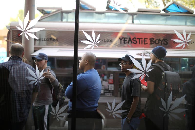 FILE PHOTO: Customers queue for recreational marijuana outside the MedMen store in West Hollywood