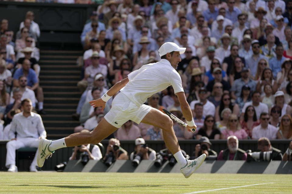 Serbia's Novak Djokovic runs to return to Australia's Nick Kyrgios in the final of the men's singles on day fourteen of the Wimbledon tennis championships in London, Sunday, July 10, 2022. (AP Photo/Alastair Grant)
