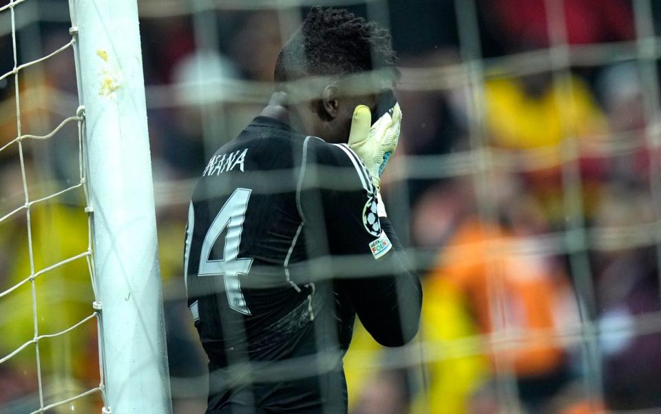 Andre Onana holds his head in his hands