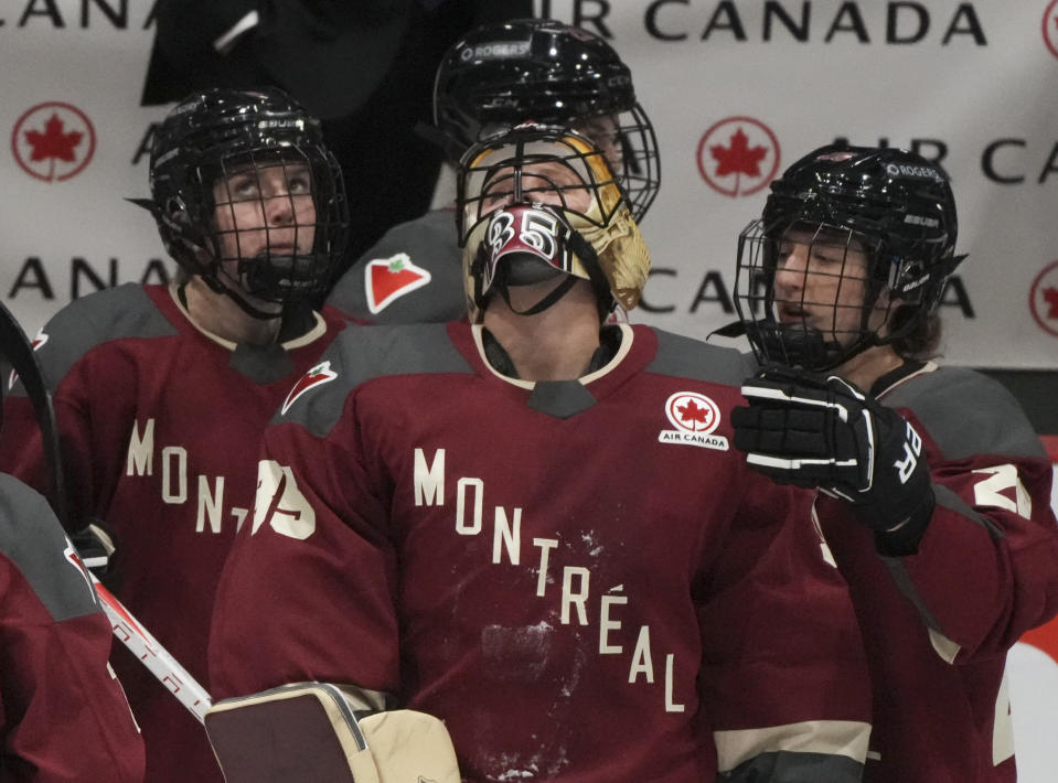 Montreal goaltender Ann-Renee Desbiens (35) reacts with teammates following their overtime loss to Boston in a PWHL hockey game in Montreal, Saturday, Jan. 13, 2024. (Christinne Muschi/The Canadian Press via AP)