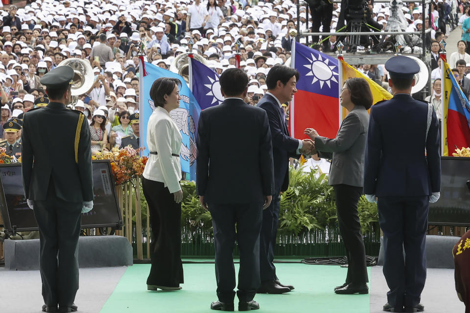 In this photo released by the Taipei News Photographer, Taiwan's new President Lai Ching-te, center, with Vice President Hsiao Bi-khim, left, is greeted by former President Tsai Ing-wen, right, during Lai's inauguration ceremony in Taipei, Taiwan, Monday, May 20, 2024. Lai was sworn in as Taiwan's new president Monday, beginning a term in which he is expected to continue the self-governing island's policy of de facto independence from China while seeking to bolster its defenses against Beijing. (Taipei News Photographer via AP)