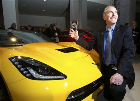 Tadge Juechter, chief engineer for the Corvette, poses with the Car of the Year Award next to a Chevrolet Corvette Stingray during the press preview day of the North American International Auto Show in Detroit, Michigan January 13, 2014. REUTERS/Rebecca Cook