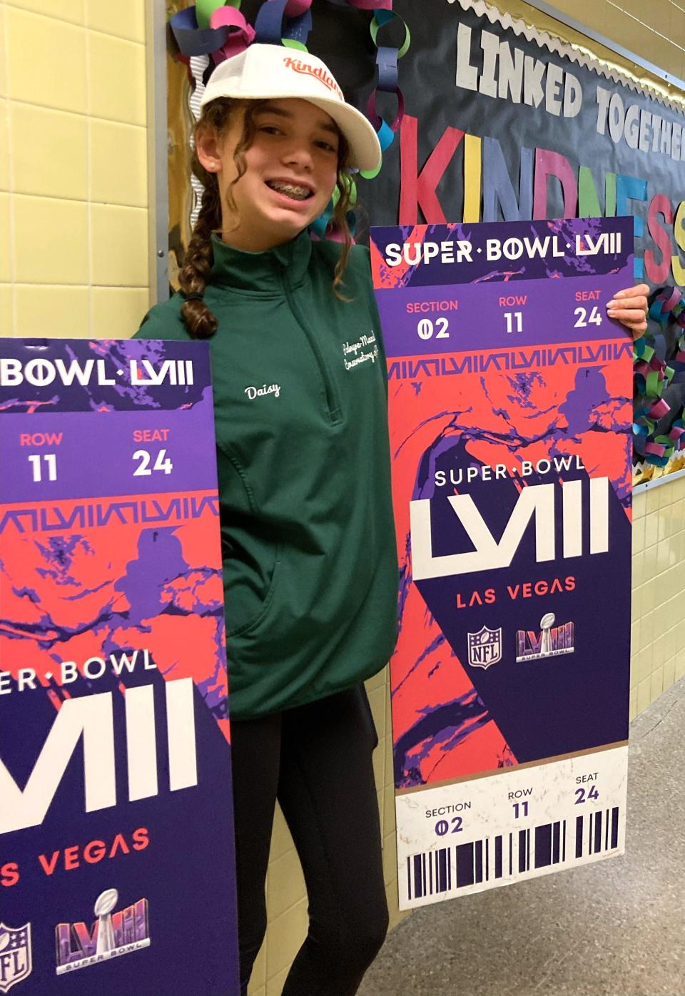 Daisy Jones, 13, holds the extra large Super Bowl tickets she won for her top video on kindness.