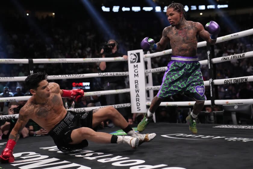 Gervonta Davis knocks down Ryan Garcia during a lightweight boxing bout Saturday.