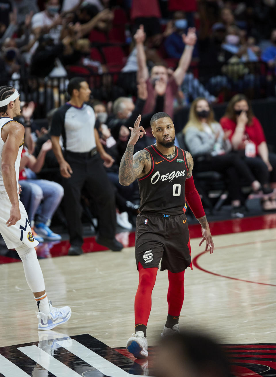 Portland Trail Blazers guard Damian Lillard reacts after making a 3-point basket against the Denver Nuggets during the first half of Game 6 of an NBA basketball first-round playoff series Thursday, June 3, 2021, in Portland, Ore. (AP Photo/Craig Mitchelldyer)