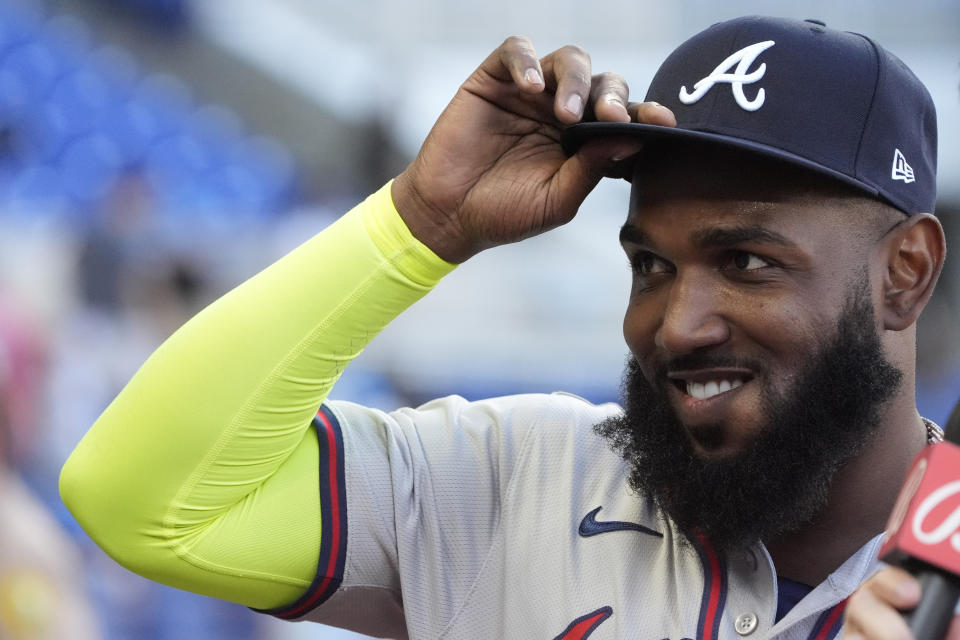 Atlanta Braves designated hitter Marcell Ozuna tips his hat to the cheering crowd as he waits to be interviewed after a baseball game against the Miami Marlins, Sunday, April 14, 2024, in Miami. (AP Photo/Wilfredo Lee)