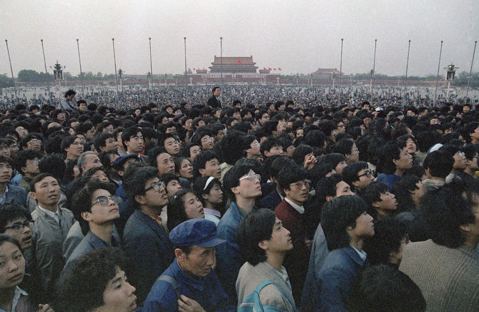 FILE - In this April 21, 1989 file photo, tens of thousands of students and citizens crowd at the Martyr's Monument at Beijing's Tiananmen Square. Over seven weeks in 1989, the student-led pro-democracy protests centered on Beijing’s Tiananmen Square became China’s greatest political upheaval since the end of the decade-long Cultural Revolution more than a decade earlier. Next week marks the 30th anniversary of the bloody crackdown that ended the protest. (AP Photo/Sadayuki Mikami, File)