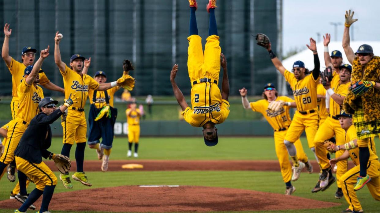 <div>Savannah Banana Malachi Mitchell (2) flips in the air as the team cheers before the start of a banana ball game against the Kansas City Monarchs at Legends Field on Friday, May 6, 2022, in Kansas City, KS. (Kent Nishimura / Los Angeles Times via Getty Images)</div>