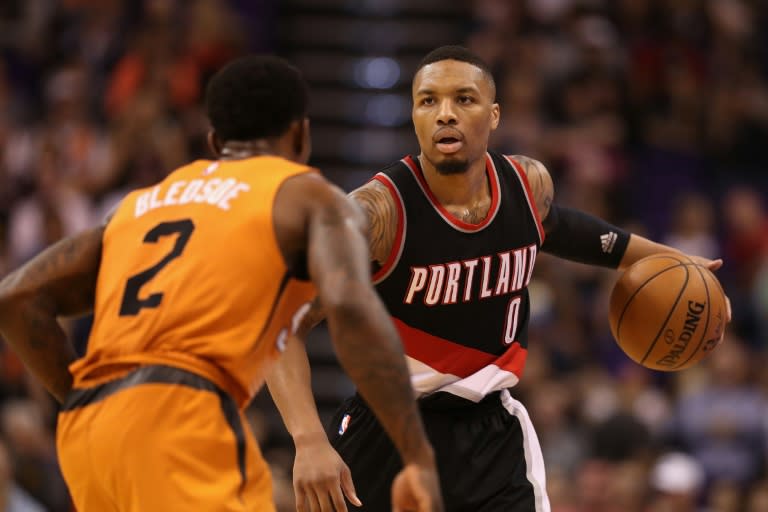 Damian Lillard (R) scored 36 points, including four free throws in the final five seconds, as the Portland Trail Blazers stunned the San Antonio Spurs 110-106