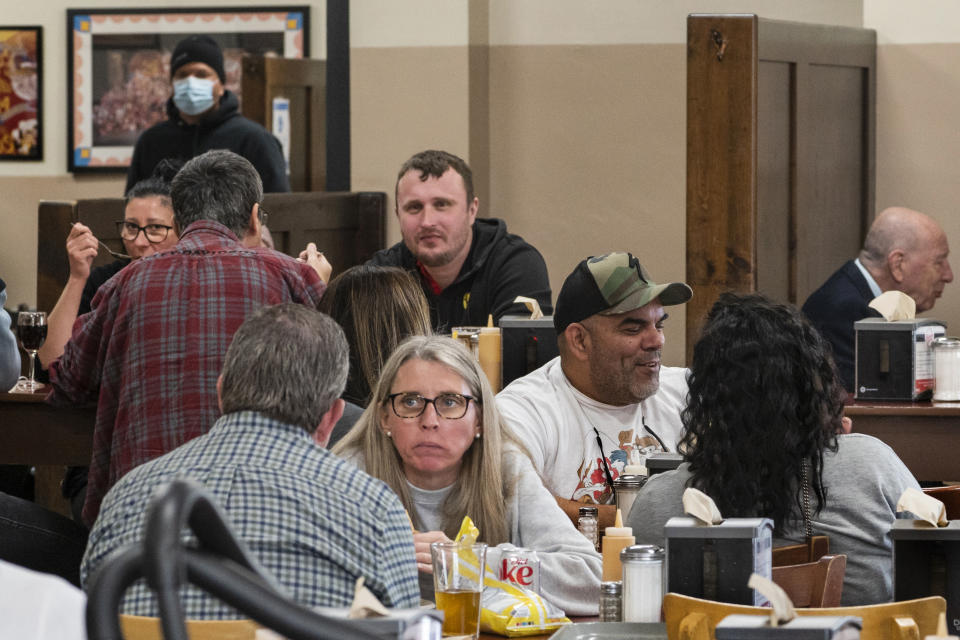 Patrons eat indoors at Philippe the Original restaurant in Los Angeles, Friday. Feb. 25, 2022. Los Angeles County will began allowing people to remove their masks while indoors if they are vaccinated as the omicron winter surge continues to ease, officials announced Thursday. Americans who have been clamoring for an end to mask-wearing have welcomed new guidance from the Centers for Disease Control and Prevention. (AP Photo/Damian Dovarganes)