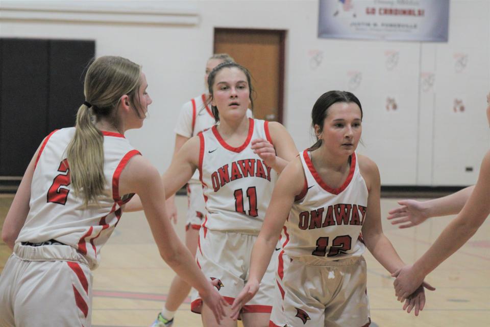 Onaway sophomore Marley Szymoniak (12) gets congratulated by teammates Sadie Decker (2) and Kailyn George (11) after making a free throw against Gaylord St. Mary on Wednesday, Feb. 14.