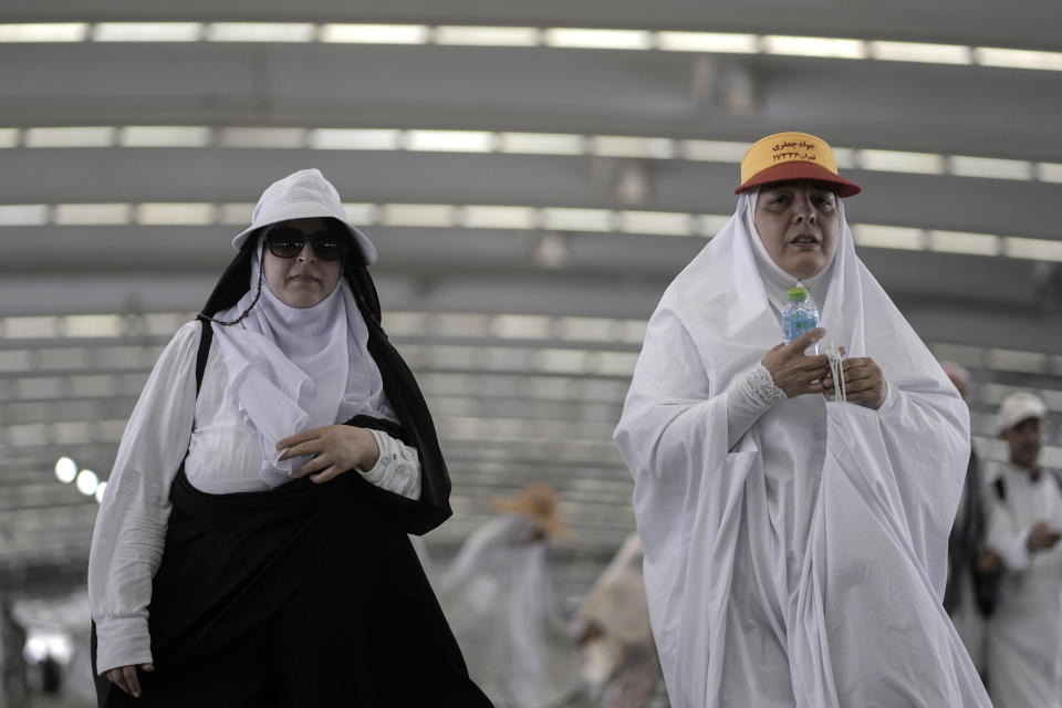 Iranian pilgrims walk to cast stones at a pillar in the symbolic stoning of the devil, the last rite of the annual Hajj pilgrimage, in Mina near the holly city of Mecca, Saudi Arabia, Thursday, June 29, 2023. (AP Photo/Amr Nabil)