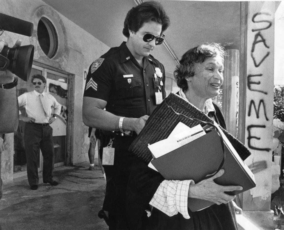 In 1988, Barbara Capitman is escorted off the terrace of the Senator Hotel after trying to place a plaque on the front door of the hotel before it was scheduled to be demolished.