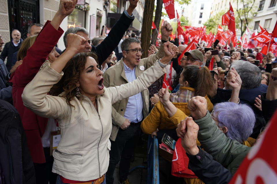 Vice-President of the Spanish Government and Minister of Finance, María Jesús Montero, and others government members, cheer to supporters of Spain's Prime Minister Pedro Sánchez gather at the PSOE party headquarter during a demonstration in Madrid, Spain, Saturday, April 27, 2024. Spain is in nail-biting suspense Monday as it waits for Prime Minister Pedro Sánchez to announce whether he will continue in office or not. Sánchez, 52, shocked the country on Thursday, announcing he was taking five days off to think about his future after a court opened preliminary proceedings against his wife on corruption allegations. (AP Photo/Andrea Comas)