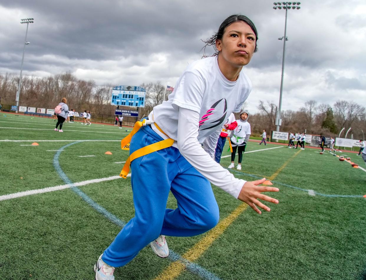 Central Falls High School's Skyla Lafleche goes for the flag during a defensive drill at the Gridiron Girls flag football camp on April 13.